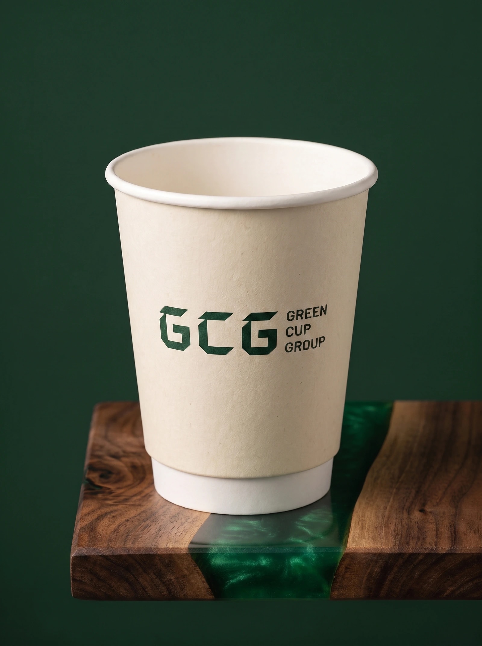 Ivory double-wall cup with green print, an uncoated paper surface and a clean tapered white base.